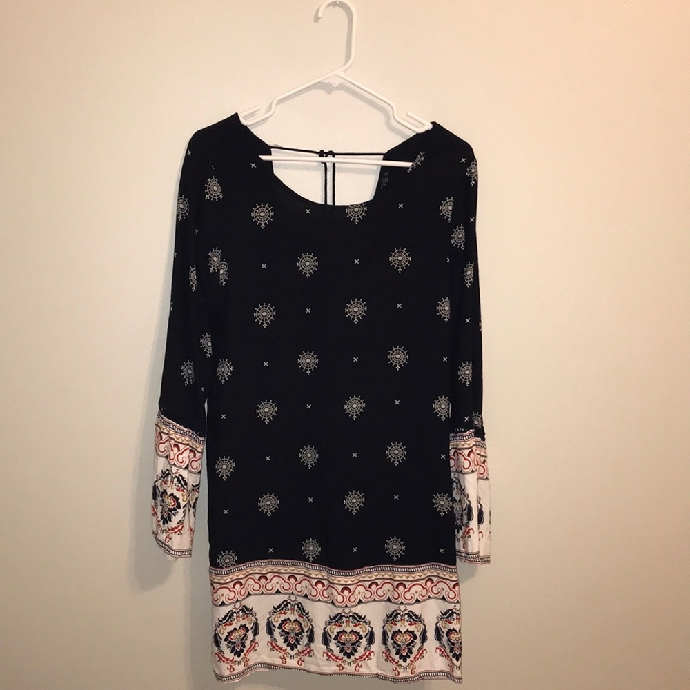 Navy, long sleeved dress with flared sleeves.